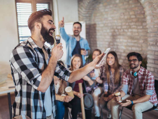 several people observing a man with a microphone